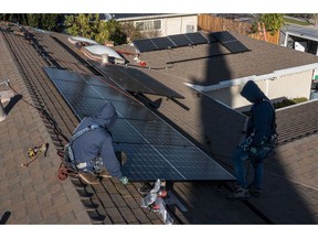 Contractors install SunRun solar panels on the roof of a home in San Jose, California, U.S., on Monday, Feb. 7, 2022. California regulators are delaying a vote on a controversial proposal to slash incentives for home solar systems as they consider revamping the measure.
