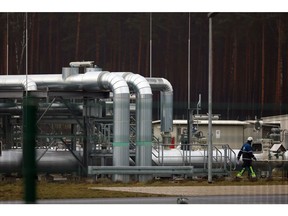 An employee walks past gas pipes at the Radeland 2 compressor station, operated by Gascade Gastransport GmbH, on the European Gas Pipeline Link (EUGAL) in Radeland, Germany, on Monday, Jan. 9 2023. Energy costs have been a key driver of inflation, and unexpectedly low demand is easing the burden on consumers and sparking optimism among European authorities. Photographer: Krisztian Bocsi/Bloomberg