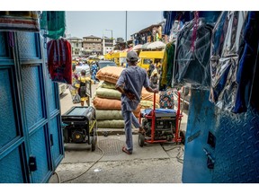 A trader with generators at a market in Lagos. Photographer: Damilola Onafuwa/Bloomberg
