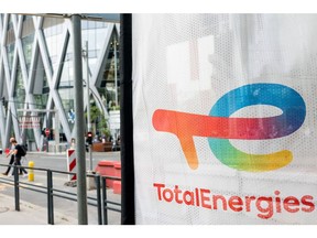 Signage for TotalEnergies SE at the company's electric vehicle charging station in the La Defense business district in Paris, France, on Thursday, July 28, 2021. TotalEnergies will extend its $2 billion buyback program into the third quarter after profit surged to a record, propelled by surging gasoline prices and soaring demand for natural gas in Europe. Photographer: Benjamin Girette/Bloomberg