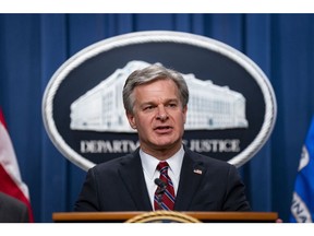 Christopher Wray, director of the Federal Bureau of Investigation (FBI), speaks during a news conference at the Department of Justice in Washington, DC, US, on Monday, Oct. 24, 2022. 13 individuals have been charged, including members of the People's Republic of China (PRC), for alleged efforts to unlawfully exert influence in the United States for the benefit of the government of the PRC, according to the Justice Department.