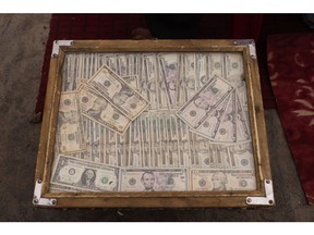 A wooden case holding US dollars bills on display at the Sara-e Shahzada exchange market in Kabul in October 2022.
