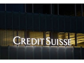 An illuminated sign on the exterior of a Credit Suisse Group AG office building at night in the Muri district of Bern, Switzerland, on Sunday, Nov. 27, 2022. Credit Suisse clients pulled as much as 84 billion Swiss francs ($88.3 billion) of their money from the bank during the first few weeks of the quarter, underlining ongoing concerns over the bank's restructuring efforts after years of scandals. Photographer: Stefan Wermuth/Bloomberg