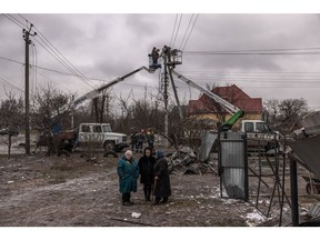 Workers repair electricity cables following Russian missile attacks near Kyiv, Ukraine, on Jan. 26. Photographer: Roman Pilipey/Getty Images