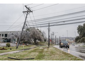Frozen power lines hang near a sidewalk in Austin, Texas, on Feb. 1, 2023