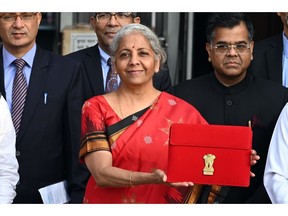 Nirmala Sitharaman, India's finance minister, center, and other members of the finance ministry leave the ministry to present the budget at the parliament in New Delhi, India, on Wednesday, Feb. 1, 2023. Sitharaman will announce the last full-year budget before Prime Minister Narendra Modi seeks a third term in elections due in the summer of 2024.