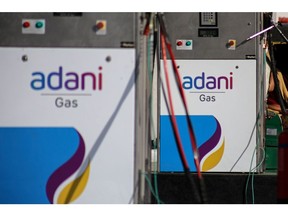 Signage of Adani Group gas station in Ahmedabad, India, on Wednesday, Feb. 1, 2023. Bonds of the Indian billionaire's flagship firm plunged to distressed levels in US trading, and the company abruptly pulled a record domestic stock offering after the Adani group suffered a $92 billion market crash. Photographer: Dhiraj Singh/Bloomberg