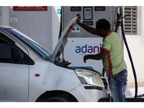 Signage of Adani Group at company's gas station in Ahmedabad, India, on Wednesday, Feb. 1, 2023. Bonds of the Indian billionaire's flagship firm plunged to distressed levels in US trading, and the company abruptly pulled a record domestic stock offering after the Adani group suffered a $92 billion market crash. Photographer: Dhiraj Singh/Bloomberg