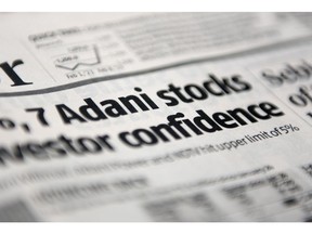 A newspaper headline featuring the Adani Group in Mumbai, India, on Thursday, Feb. 9, 2023. Adani stocks fell, ending a two-day rally, after MSCI Inc. said it was reviewing the amount of shares linked to the group that were freely tradable in public markets. Photographer: Indranil Aditya/Bloomberg
