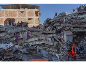 Rescue teams work at the site of collapsed residential buildings in Hatay, Turkey, on Friday, Feb. 10, 2023. Turkish President Recep Tayyip Erdogan is facing mounting criticism from earthquake survivors and opposition parties over the country's poor construction record and what they say has been an inadequate response to one of its worst natural disasters. Photographer: David Lombeida/Bloomberg