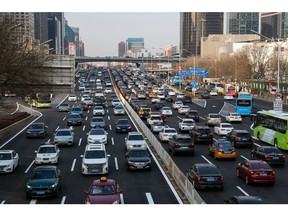 Vehicles travel along a road in Beijing, China, on Wednesday, Feb. 15, 2023. President Xi Jinping's push for a consumer-led economic recovery has hit a new barrier: Chinese citizens misusing cheap consumer loans.