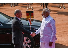 Olaf Scholz, left, greets Narendra Modi, in New Delhi, on Feb. 25.