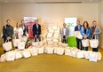 The Green Shield executive committee (left to right): Scot Hopkins, Mila Lucio, JP Girard, Mark Rolnick, Zahid Salman, Joe Blomeley,  Anela Nikic and Brent Allen, standing with over 200 care packages assembled by employees during a recent corporate training event in support of Hiatus House, a Windsor-Essex emergency shelter for women and children faced with domestic violence and abuse.  SUPPLIED