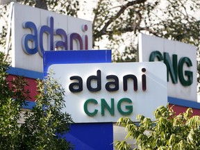 Signage of Adani's compressed natural gas station are displayed at company's outlet in Ahmedabad, India, Feb. 2, 2023. Losses for the troubled Adani Group, India's second-largest conglomerate, deepened on Friday as shares in its flagship company tumbled another 25%, extending over a week of declines that have wiped out tens of billions of dollars in market value.