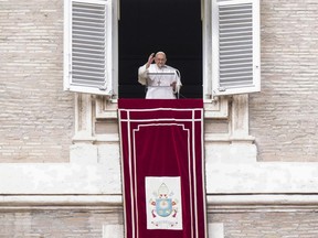 Pope Francis delivers his blessing as he recites the Angelus noon prayer from the window of his studio overlooking St. Peter's Square, at the Vatican, Sunday, Feb. 26, 2023.