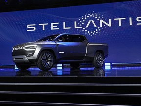 FILE - The Ram 1500 Revolution electric battery powered pickup truck is displayed on stage during the Stellantis keynote at the CES tech show on Jan. 5, 2023, in Las Vegas. Automaker Stellantis has reported its earnings grew in 2022 from a year earlier as it pressed an industrywide strategy to shift into electric vehicles, leading to a jump in sales. The company said Wednesday, Feb. 22, 2023, that net revenue of 179.6 billion euros was up 18% from 2021. It reported net profit of 16.8 billion, up 26% from 2021.
