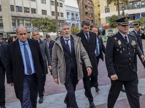 FILE - Interior Minister of Spain Fernando Grande-Marlaska, center, arrives to the church in Algeciras, Spain, on Jan. 26, 2023. Spain's government on Wednesday, Feb. 8, 2023 pledged stronger action against cybercrime, which according to official data accounts for about a fifth of all offenses registered in the country. Interior minister Fernando Grande-Marlaska said police would be given additional staff, funding and resources to address online crime. He said reported cases of cybercrime were up 72% last year.