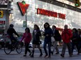 Pedestrians walk past a Canadian Tire store in Toronto.