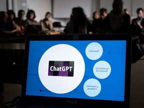 Teachers are seen behind a laptop during a workshop on ChatGPT in Geneva.