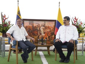 In this photo released by the Colombian Presidential Press Office, Colombia's President Gustavo Petro, left, and Venezuela's President Nicolas Maduro, right, meet before signing a bilateral agreements at the International Bridge Atanasio Girardot, on the border between Venezuela and Colombia, Thursday, Feb.16, 2023.
