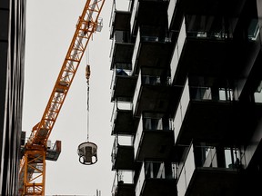 A crane moves concrete to be poured at a building site in Montreal.