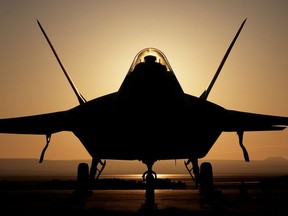 393295 05: (FILE PHOTO) An F-22 Raptor 4001 stealth fighter is silhouetted against the setting sun in this undated file photo. The Pentagon gave Lockheed Martin approval August 15, 2001 to begin production of the stealth jet to replace the Air Force''s F-15 fighters.