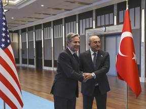 U.S. Secretary of State Antony Blinken, left, shakes hands with Turkish Foreign Minister Mevlut Cavusoglu before their meeting in Ankara, Turkey, Monday, Feb. 20, 2023.