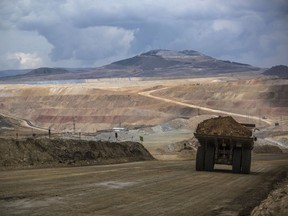 A dump truck hauls soil away from a pit at a gold mine in Peru.