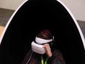 A woman wears Huawei VR2 goggles at the Huawei booth during CES International, Tuesday, Jan. 9, 2018, in Las Vegas. GrinhausՠToronto law firm is one of a growing group of companies setting up offices in a virtual world called the metaverse to push the envelope and learn more about the emerging technology.