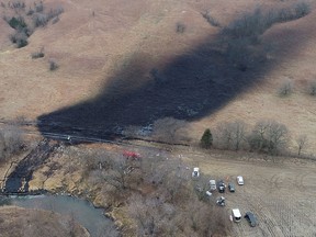 Emergency crews work to clean up the crude oil spill, following the leak at the Keystone pipeline operated by TC Energy in rural Washington County, Kansas on Dec. 9, 2022.