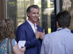 FILE - California Gov. Gavin Newsom speaks with reporters said on Friday, Oct. 7, 2022, in Sacramento. California lawmakers are having their first public hearing on a proposal to penalize some oil company profits. Newsom proposed the law in response to record high gas prices over the summer.