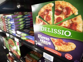 Delissio frozen pizzas are shown in the frozen food aisle at a grocery store in Toronto on Thursday, Feb. 2, 2023.