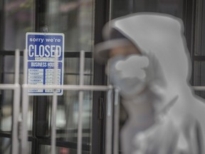 A closed sign on a Toronto storefront door during the COVID-19 pandemic.