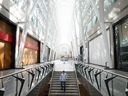 A pedestrian walks down stairs at Brookfield Place in the financial district of Toronto.