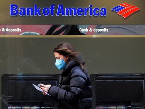A person walks past a Bank of America Corp. sign in the Manhattan borough of New York City.