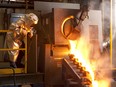 A worker pouring gold at Agnico-Eagle Mines Ltd.'s Meadowbank mine.