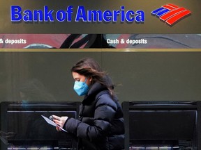 A person walks past a Bank of America sign in the Manhattan borough of New York City.