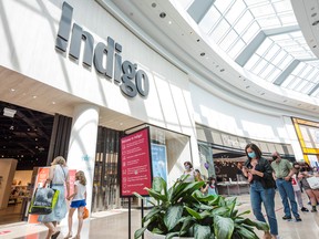 Shoppers wait in line to enter the , Indigo Books & Music Inc. store in Toronto's Sherway Gardens mall.