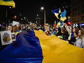 Protesters hold a giant Ukranian flag during a gathering in support of Ukraine on the first anniversary of the Russian invasion in Sofia, Bulgaria.