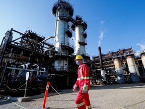 A Shell employee walks past the company's Quest carbon capture and storage facility in Fort Saskatchewan, Alta.