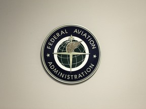 FILE - A Federal Aviation Administration sign hangs in the tower at John F. Kennedy International Airport in New York, March 16, 2017. Congress is taking up key aviation legislation just after close calls between planes at airports in New York and Texas. A House committee held the first hearing Tuesday, Feb. 7, 2023, on legislation that will govern the Federal Aviation Administration.