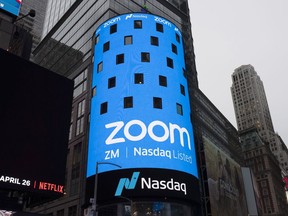 FILE - This April 18, 2019, file photo shows a sign for Zoom Video Communications ahead of the company's Nasdaq IPO in New York. The video-conferencing service is cutting about 1,300 jobs, or approximately 15% of its workforce. CEO Eric Yuan said in a blog post Tuesday, Feb. 7, 2023, that the company ramped up staffing during the COVID-19 pandemic, when businesses became increasingly reliant on its service as people worked from home. Yuan said Zoom grew three times in size within 24 months to manage demand.