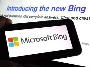 FILE - The Microsoft Bing logo and the website's page are shown in this photo taken in New York on Tuesday, Feb. 7, 2023. Microsoft is ready to take its new Bing chatbot mainstream -- less than a week after making major fixes to stop the artificially intelligent search engine from going off the rails. The company said Wednesday, Feb. 22, it is bringing the new AI technology to its Bing smartphone app, as well as the app for its Edge internet browser.