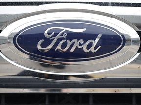 FILE - In this Oct. 20, 2019 file photograph, a Ford logo is displayed at a Ford dealership in Littleton, Colo. Ford will return to Formula One as the engine provider for Red Bull Racing in a partnership announced Friday, Feb. 3, 2023, that begins with immediate technical support this season and engines in 2026.