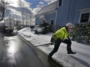 Peter Ellingwood delivers heating oil, Tuesday, Jan. 31, 2023, in Farmington, Maine. On Friday, the U.S. government issues the January jobs report.