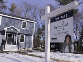 A "For Sale" sign is posted outside a single family home, Tuesday, Feb. 7, 2023, in Derry, N.H. On Tuesday, the National Association of Realtors reports on sales of existing homes in January.