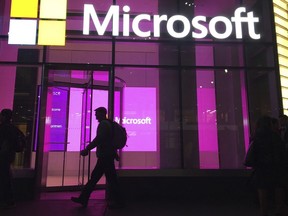 FILE - People walk past a Microsoft office in New York on Nov. 10, 2016.