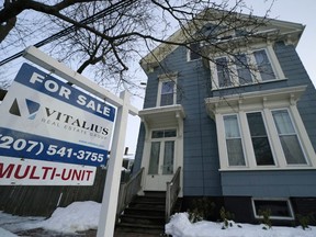 A sign announces a home for sale on Munjoy Hill, Wednesday, Jan. 25, 2023, in Portland, Maine. On Thursday, Freddie Mac reports on this week's average U.S. mortgage rates.