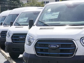 File - Ford E-Transit electric vans are displayed at a Gus Machado Ford dealership Monday, Jan. 23, 2023, in Hialeah, Fla. The U.S. Postal Service is buying 9,250 of the E-Transit vans.