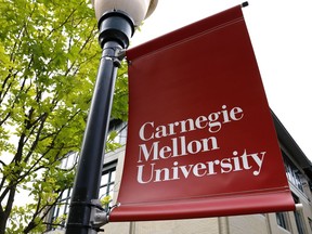 FILE - A Carnegie Mellon University sign is displayed outside Baker Hall on the university's campus in Pittsburgh, June 7, 2019. Carnegie Mellon University and the Norman and Ruth Rales Foundation, named for a home-building supplies entrepreneur and his wife who built their fortune despite early struggles, hope a $150 million initiative will support a new generation of students trying to achieve that American dream.